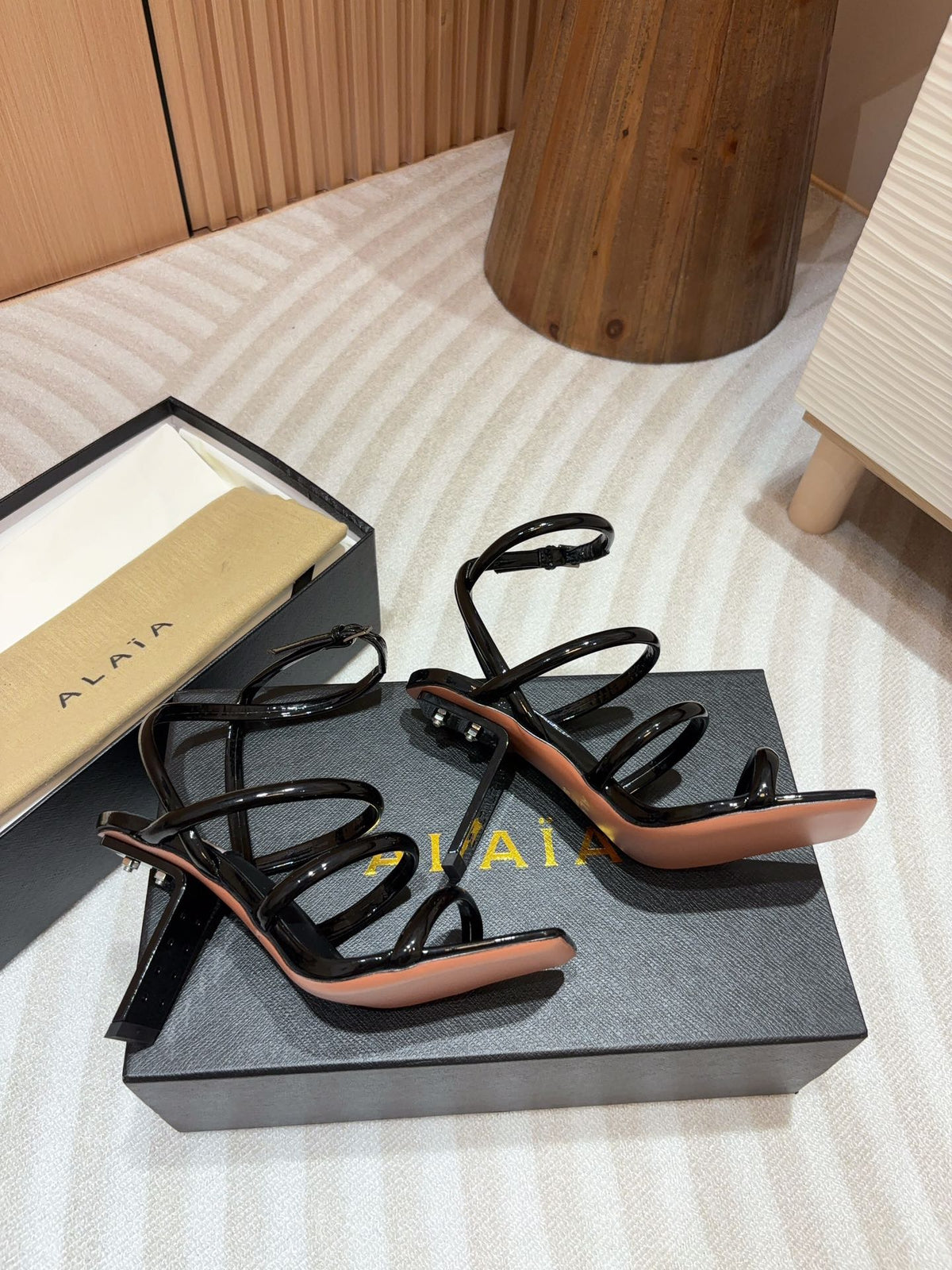ALAIA THREE-STRAPS HIGH HEEL SANDALS IN BLACK PATENT LAMBSKIN