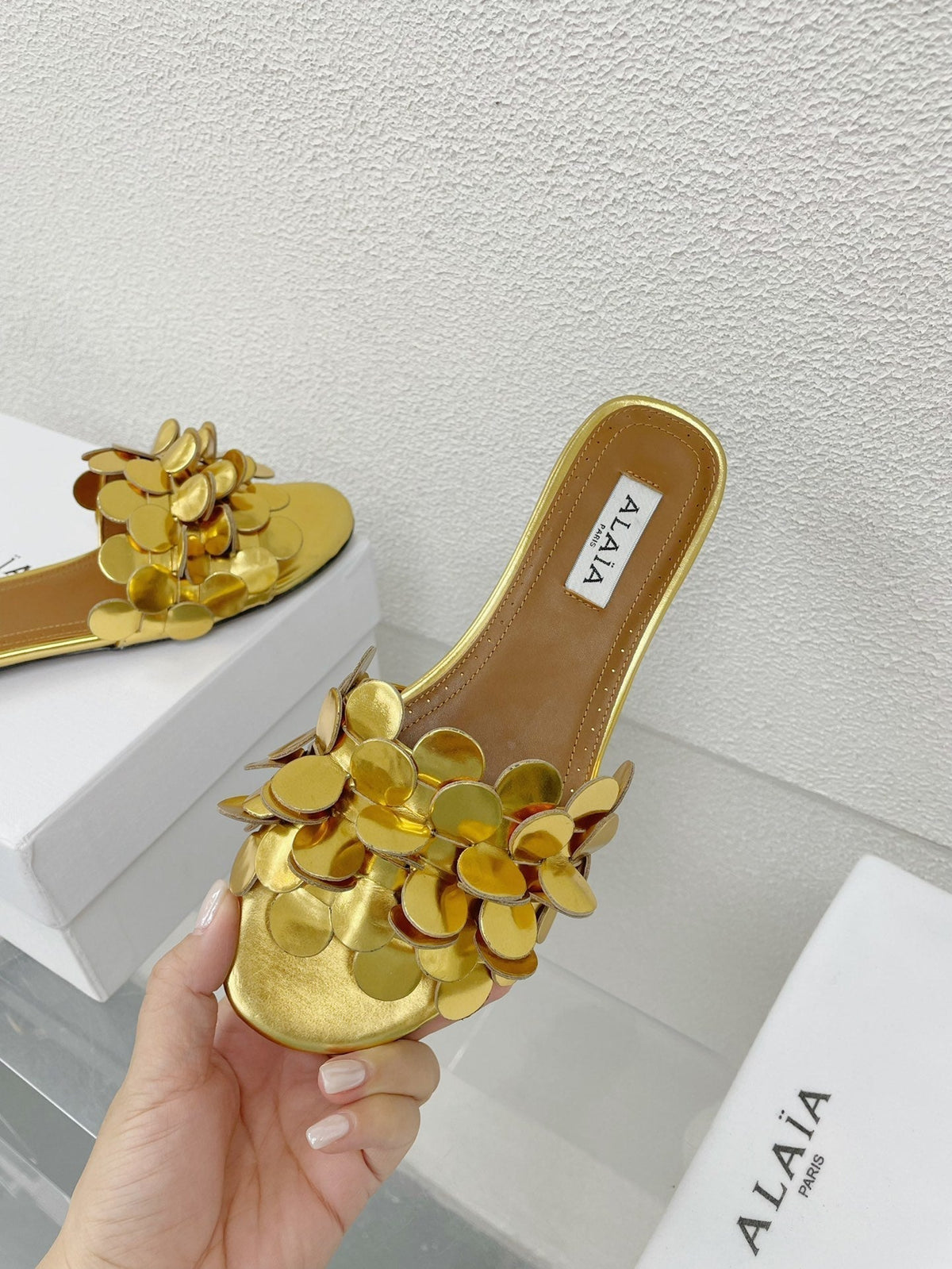 ALAIA FLAT MULE IN GOLDEN GLOSSY LAMBSKIN