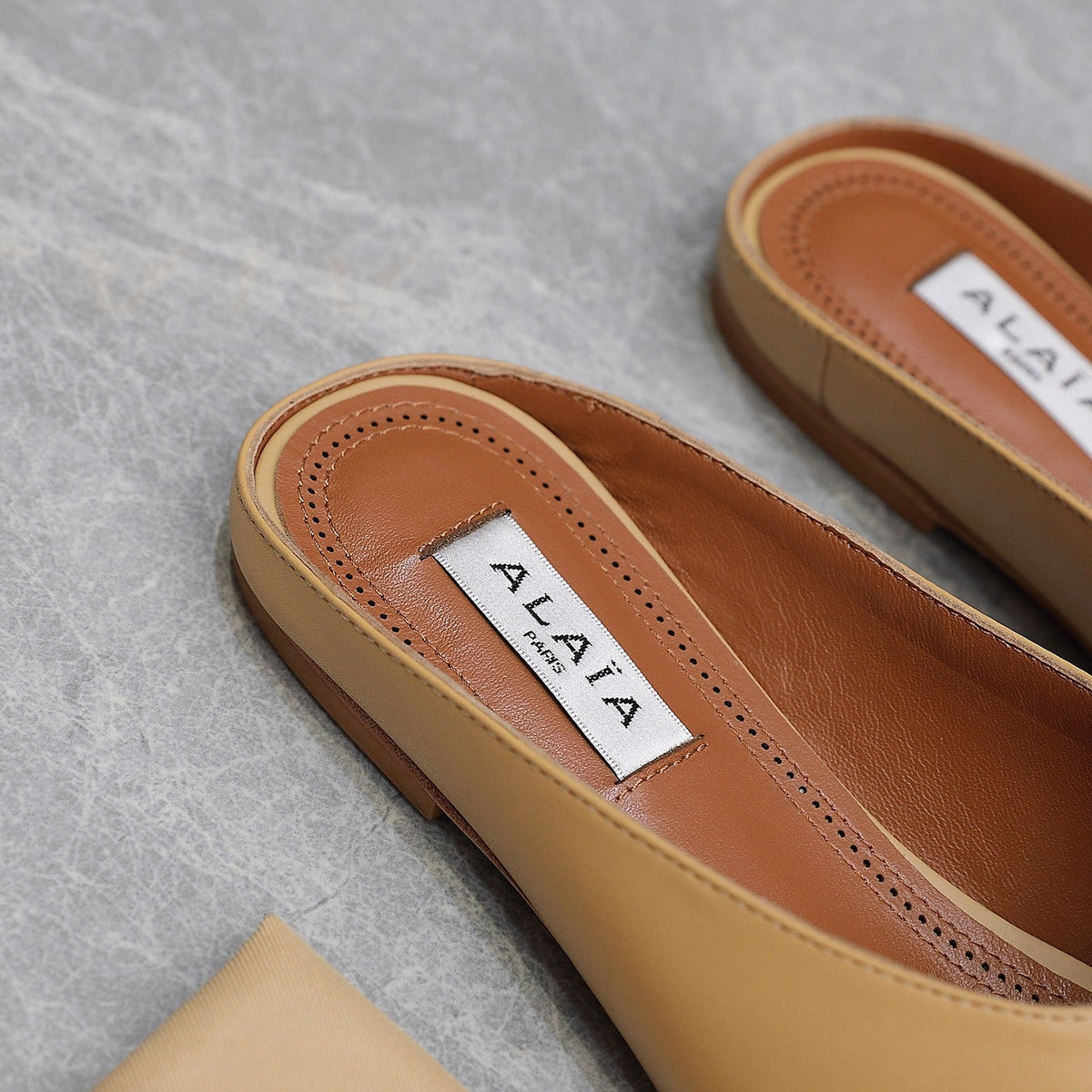 ALAIA FLAT MULE IN SEPIA TAN LAMBSKIN