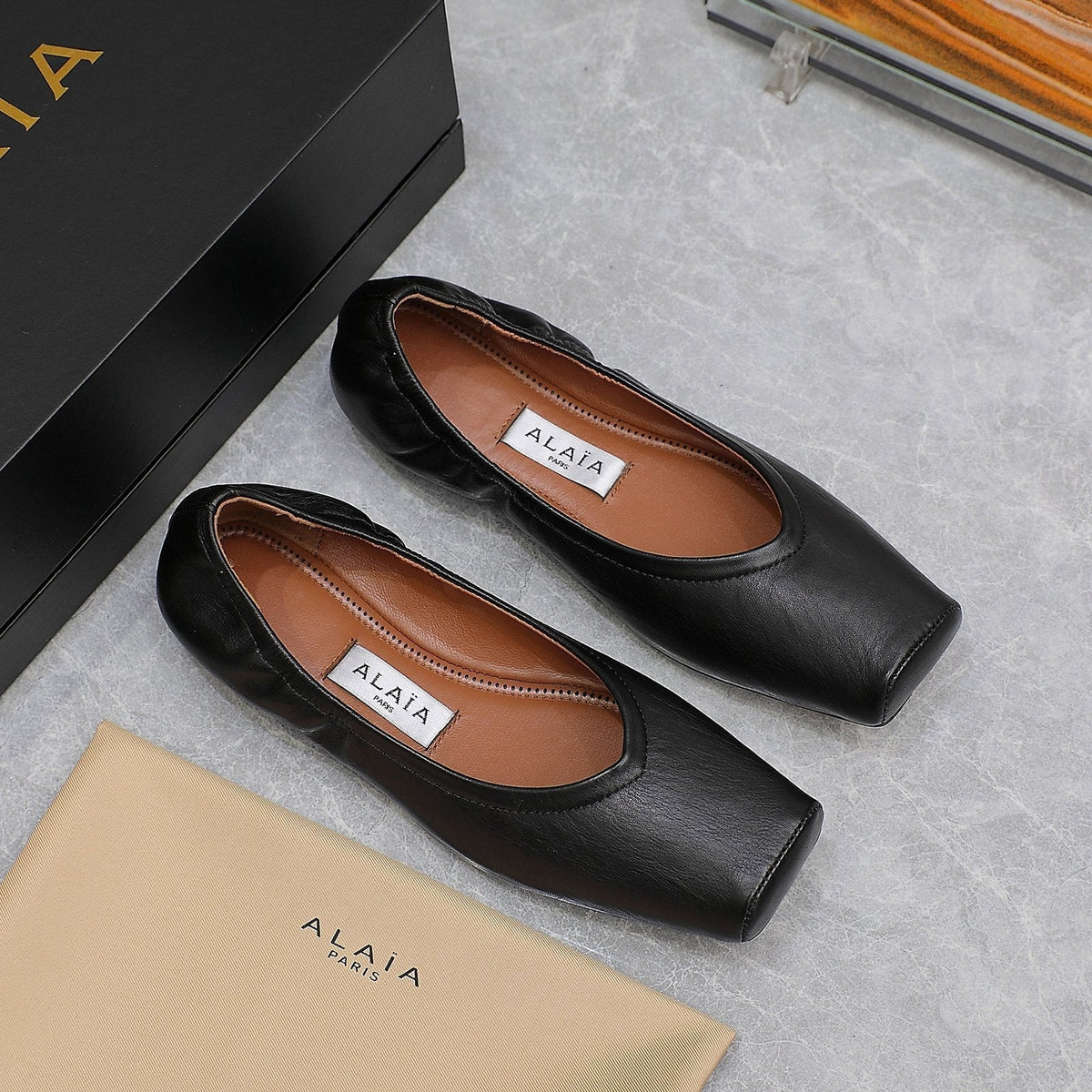 ALAIA BALLET FLATS IN BLACK SMOOTH CALFSKIN